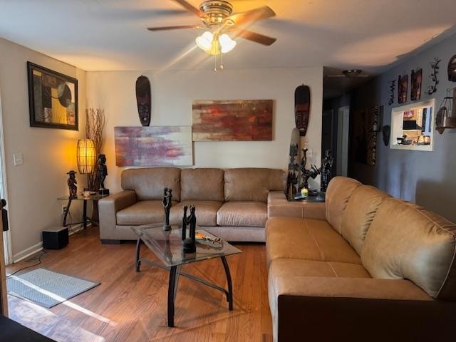 living room featuring ceiling fan and wood-type flooring