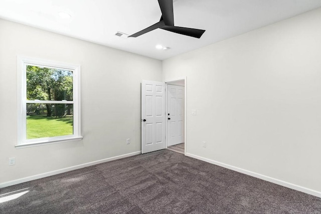 empty room with ceiling fan and carpet floors