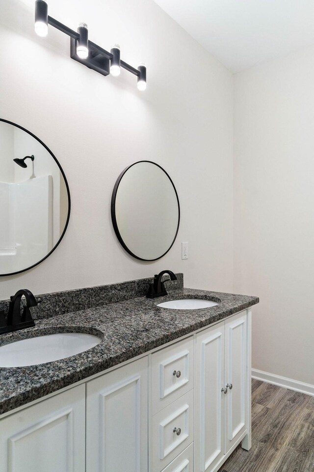 bathroom featuring vanity and hardwood / wood-style floors