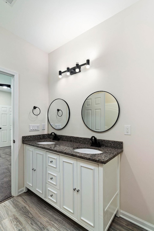 bathroom with vanity and hardwood / wood-style floors