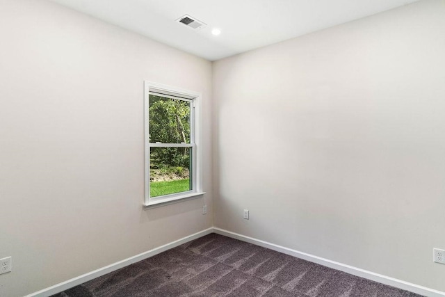 empty room featuring dark carpet