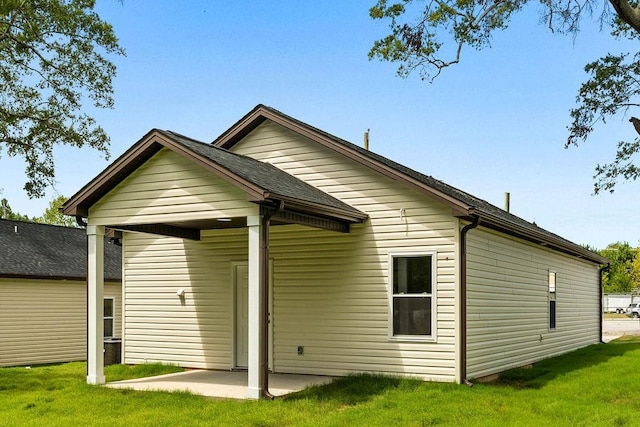 rear view of property with a lawn