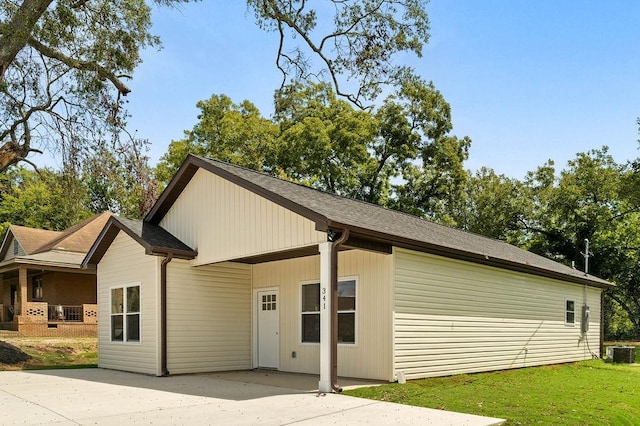 back of property with cooling unit and a lawn