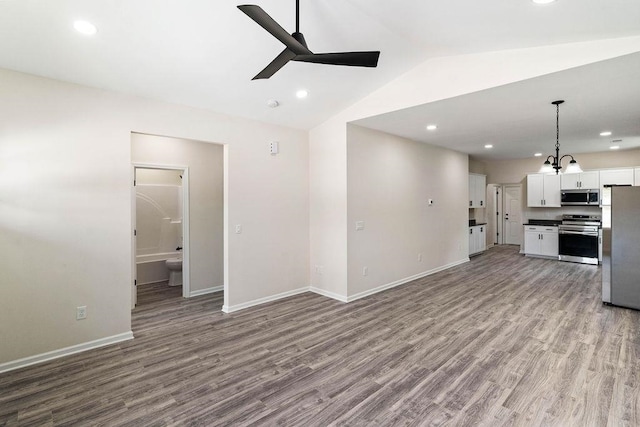 unfurnished living room with lofted ceiling, hardwood / wood-style floors, and ceiling fan