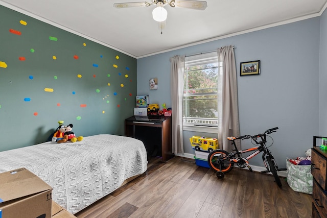 bedroom with ceiling fan, dark hardwood / wood-style flooring, and ornamental molding