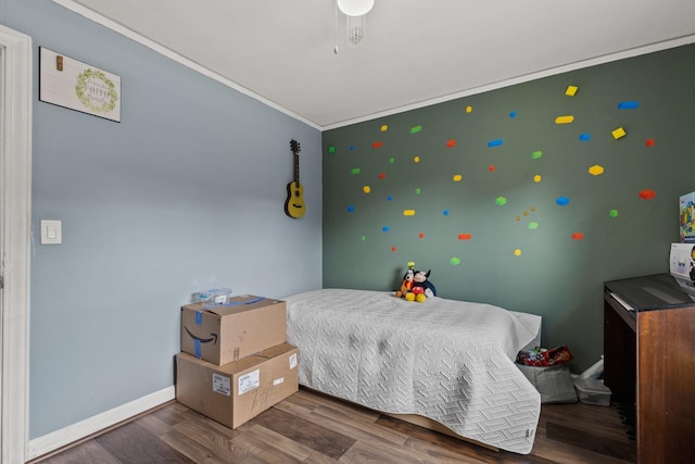 bedroom with ornamental molding and dark hardwood / wood-style flooring