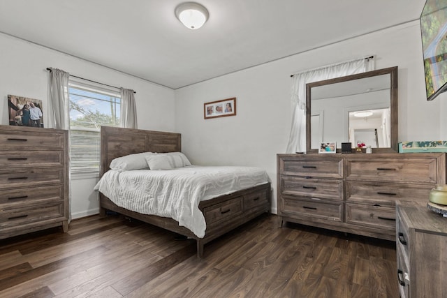 bedroom with dark hardwood / wood-style floors