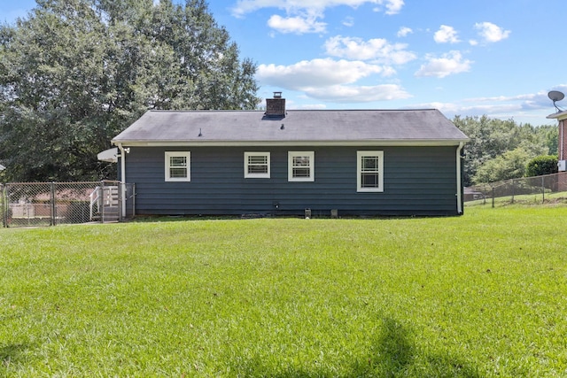 rear view of property with a yard