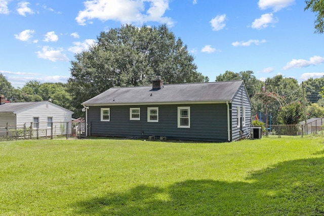 rear view of house featuring a yard