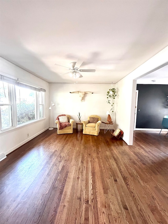 interior space with ceiling fan and dark hardwood / wood-style floors