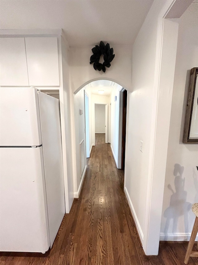 corridor featuring dark wood-type flooring