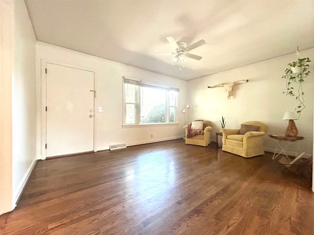 interior space with dark wood-type flooring and ceiling fan