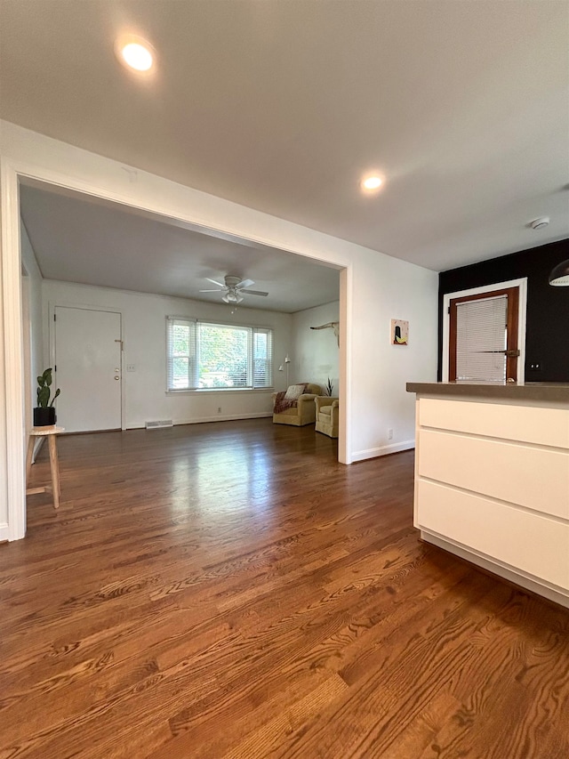 unfurnished living room featuring hardwood / wood-style floors and ceiling fan