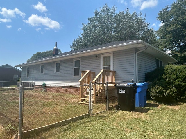 rear view of property with a lawn