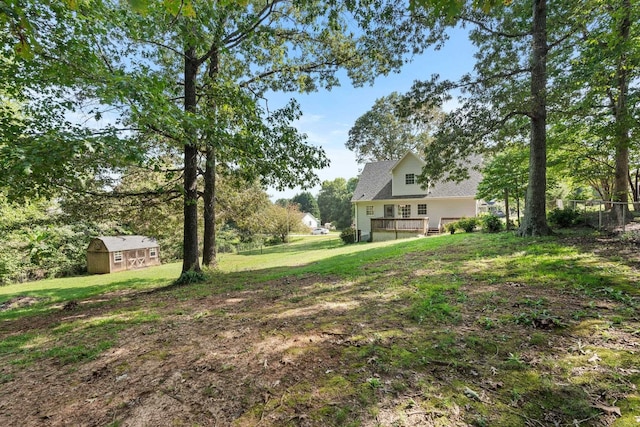 view of yard with an outdoor structure and a wooden deck