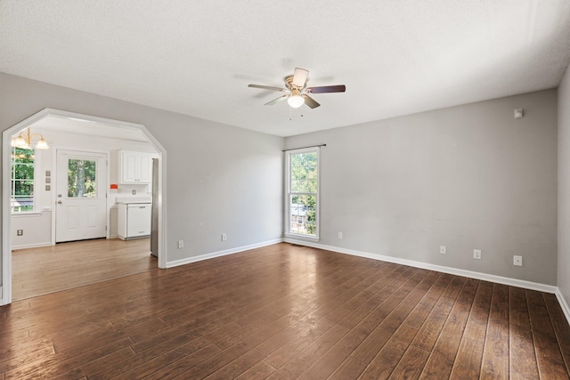 spare room featuring ceiling fan, hardwood / wood-style flooring, plenty of natural light, and a textured ceiling