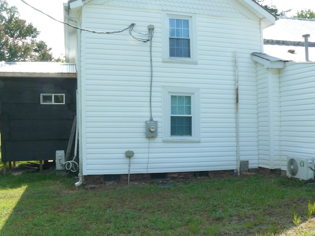 view of property exterior featuring ac unit and a yard