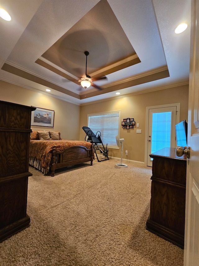 carpeted bedroom with a raised ceiling, ceiling fan, and ornamental molding