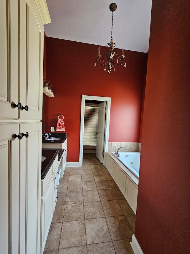 bathroom with vanity, a bathtub, tile patterned floors, and a chandelier