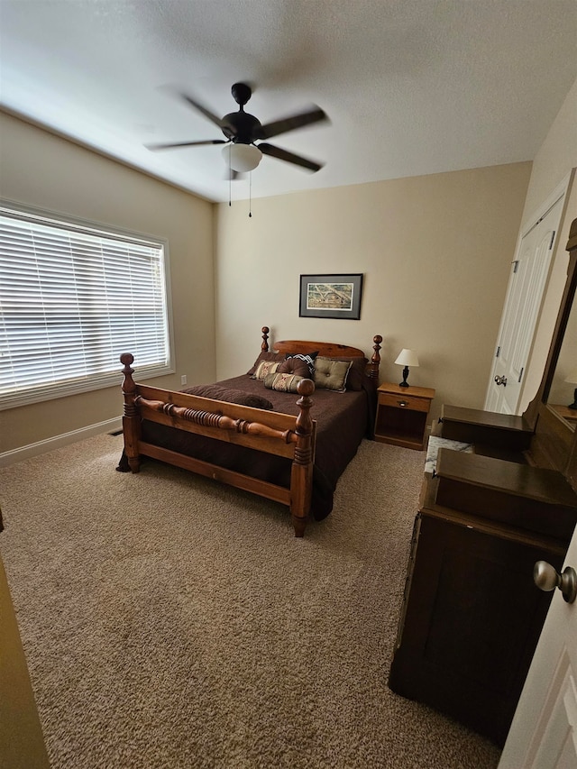 bedroom featuring a textured ceiling, carpet flooring, and ceiling fan