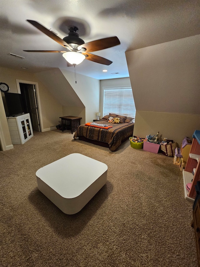 carpeted bedroom with vaulted ceiling, a textured ceiling, and ceiling fan