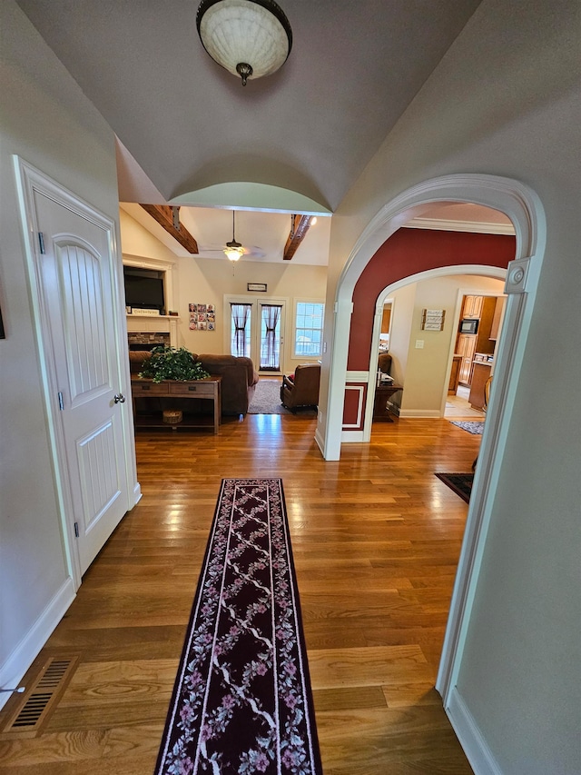 hallway featuring lofted ceiling and wood-type flooring