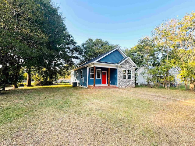 view of front facade with a front yard and central AC unit