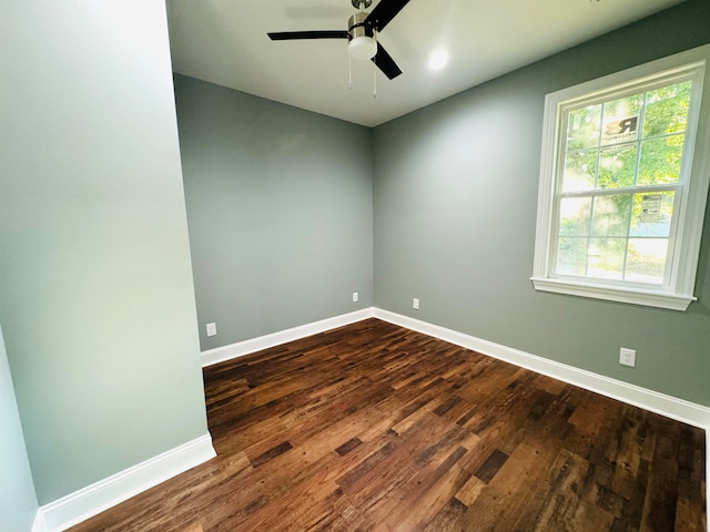 unfurnished room with dark hardwood / wood-style flooring and ceiling fan