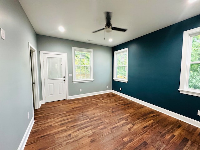 spare room with ceiling fan, hardwood / wood-style flooring, and plenty of natural light