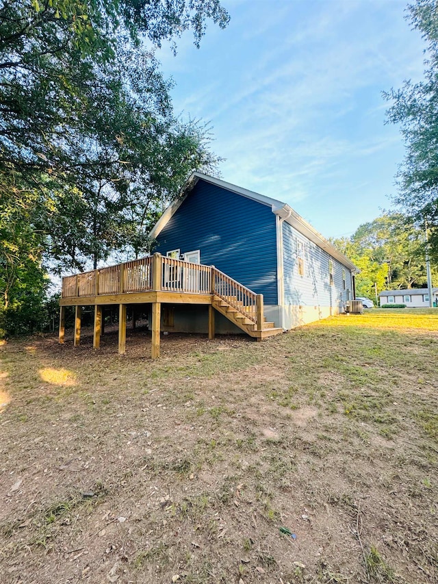 rear view of property featuring a wooden deck