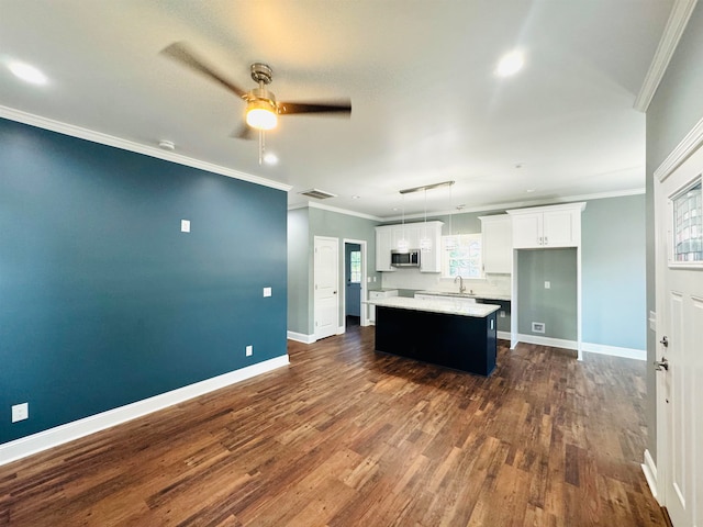 kitchen with a kitchen island, pendant lighting, dark wood-type flooring, white cabinetry, and ceiling fan