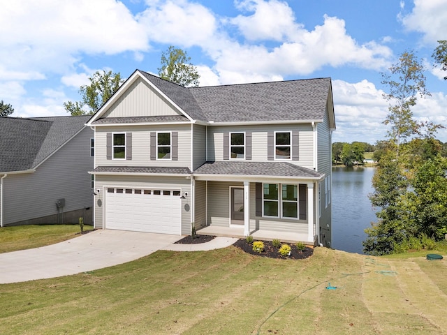 view of front of house with a water view, a garage, and a front yard