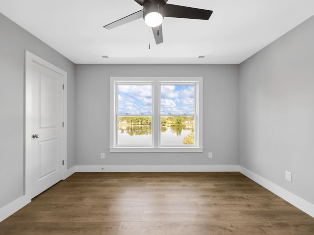 spare room featuring ceiling fan and dark hardwood / wood-style flooring