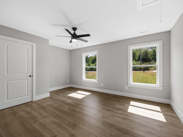 spare room with ceiling fan and dark hardwood / wood-style floors