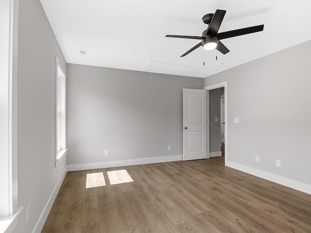 empty room featuring hardwood / wood-style floors and ceiling fan