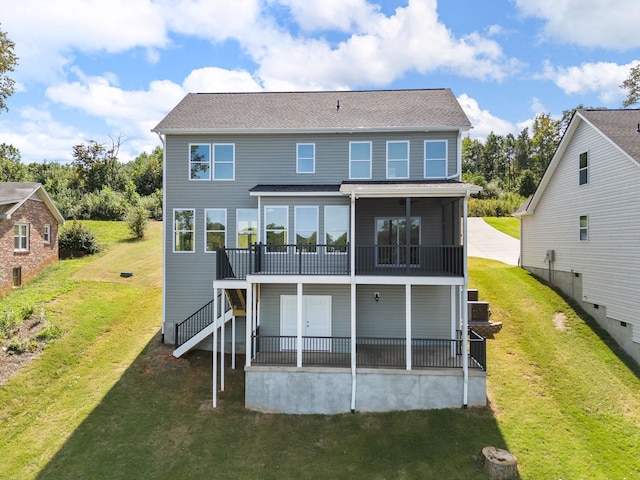 rear view of property featuring a yard and a deck