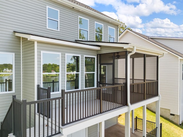 back of house with a sunroom and a deck