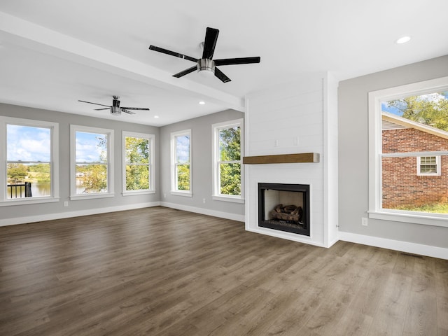 unfurnished living room featuring wood-type flooring, a fireplace, and ceiling fan