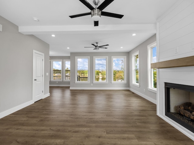 unfurnished living room with ceiling fan and dark hardwood / wood-style flooring