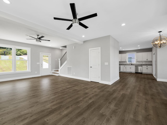 unfurnished living room featuring ceiling fan with notable chandelier, dark hardwood / wood-style flooring, and sink