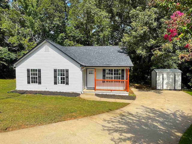 view of front of property with a front lawn, a porch, and a storage shed