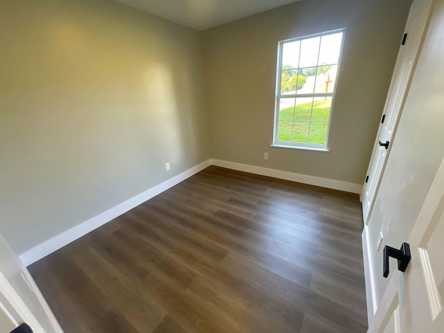 empty room with dark hardwood / wood-style floors