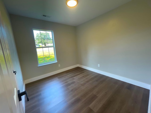 unfurnished room featuring dark hardwood / wood-style flooring