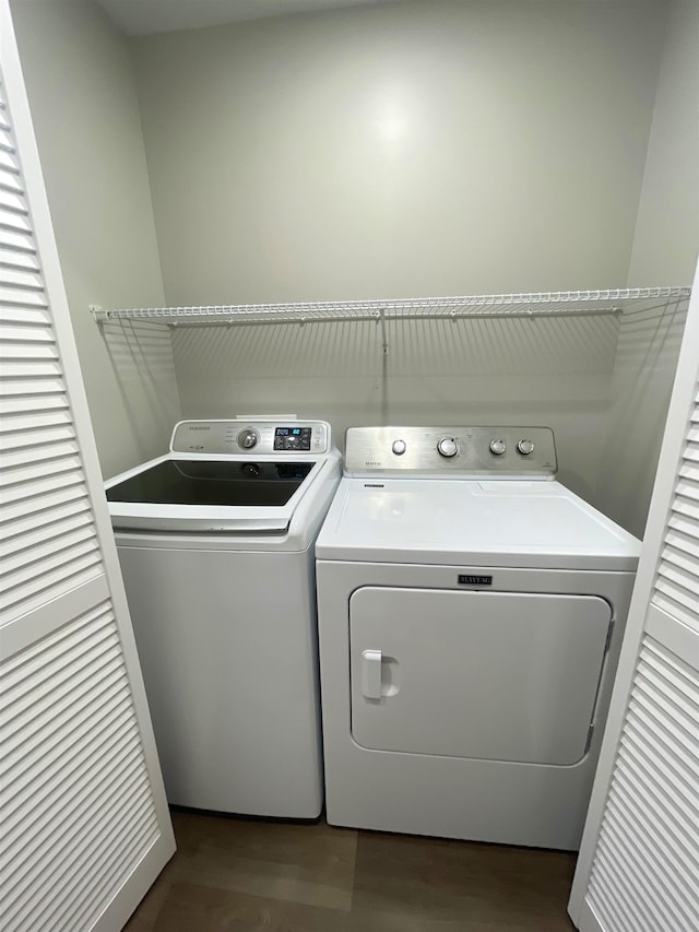 laundry area with separate washer and dryer and hardwood / wood-style floors