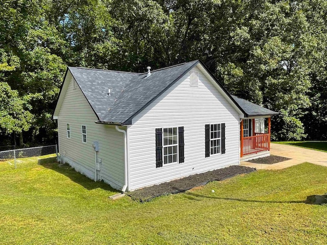 view of side of home featuring a lawn