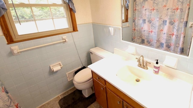 bathroom featuring vanity, a shower with curtain, wainscoting, tile walls, and toilet