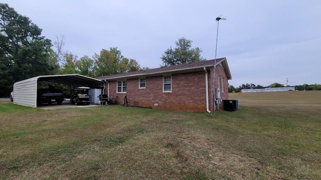 view of side of home featuring a detached carport, a lawn, brick siding, and crawl space