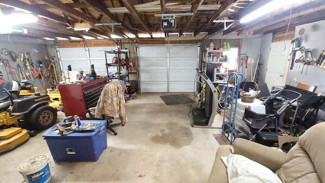 garage with a workshop area and a garage door opener