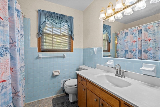 bathroom featuring tile patterned flooring, visible vents, tile walls, toilet, and vanity