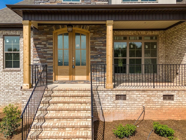 view of exterior entry with a porch